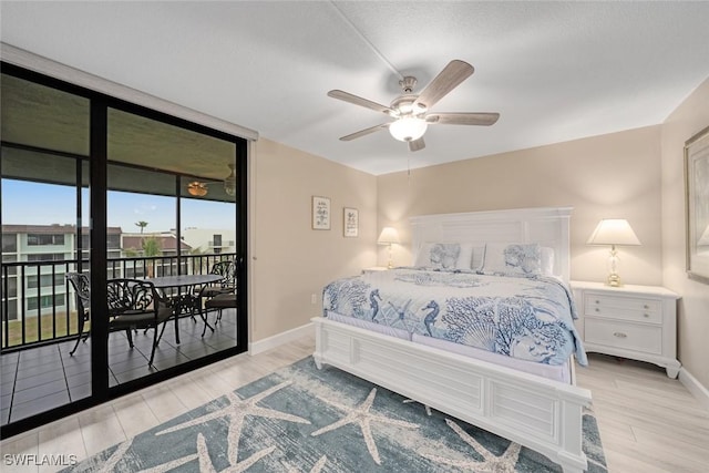 bedroom featuring light hardwood / wood-style flooring, a wall of windows, ceiling fan, and access to outside