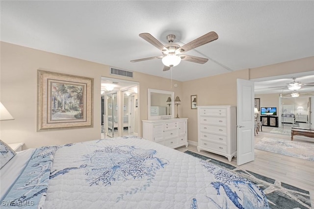 bedroom with light hardwood / wood-style flooring and ceiling fan