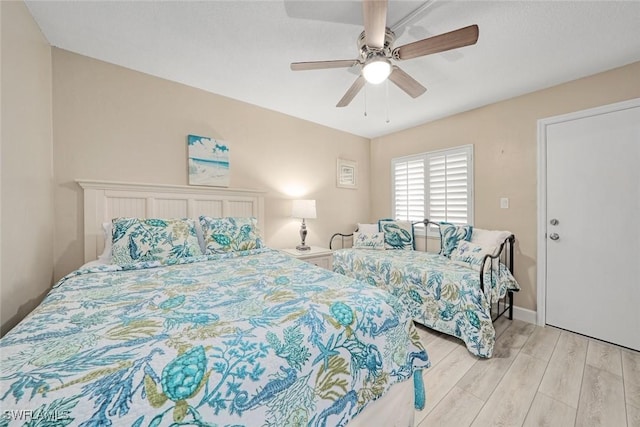 bedroom featuring light wood-type flooring and ceiling fan