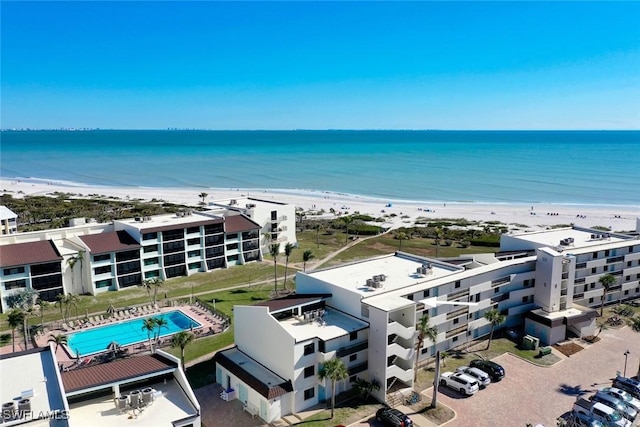 birds eye view of property featuring a beach view and a water view