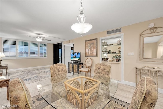 dining room with ceiling fan and light hardwood / wood-style floors