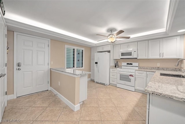 kitchen with white appliances, white cabinetry, sink, a raised ceiling, and kitchen peninsula