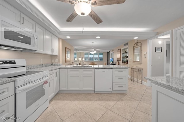 kitchen with white appliances, white cabinetry, sink, kitchen peninsula, and light tile patterned floors