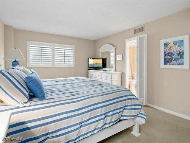 carpeted bedroom with ensuite bath