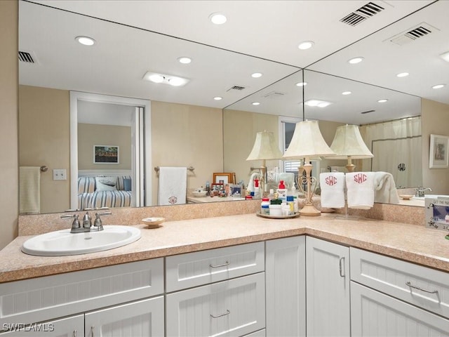 kitchen with sink, white cabinets, and hanging light fixtures