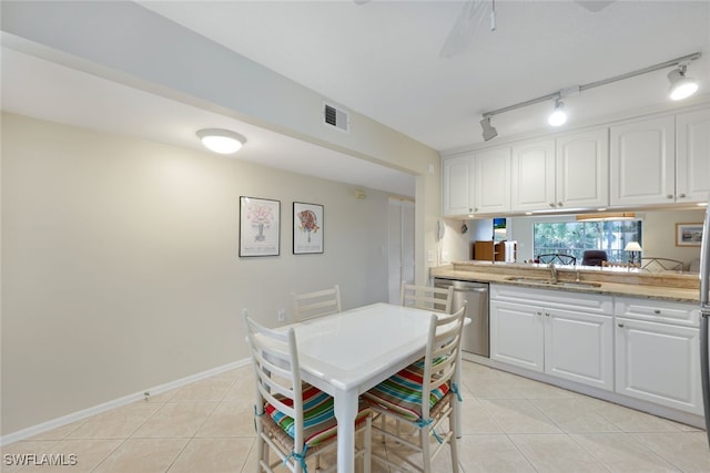 3072 Sandpiper Bay Cir Unit M203, Naples, FL 34112 - dining space featuring light tile patterned flooring and rail lighting