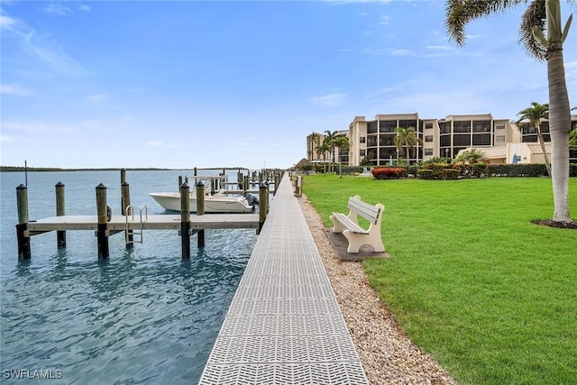 dock area featuring a yard and a water view