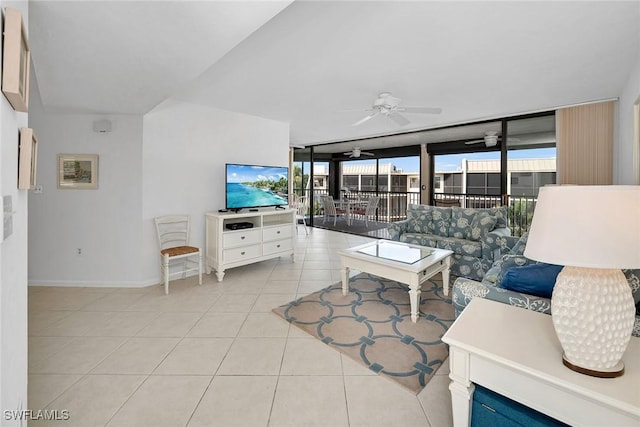 tiled living room with ceiling fan and a wall of windows