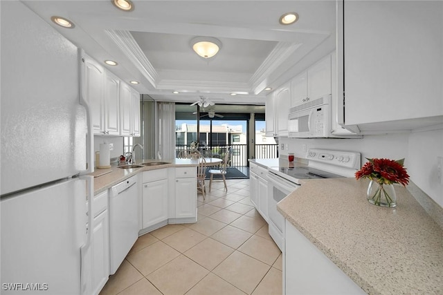 kitchen featuring sink, white cabinetry, a raised ceiling, white appliances, and ornamental molding