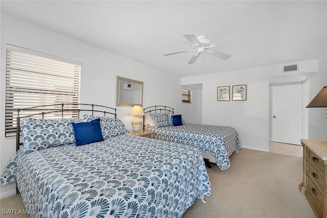 bedroom with ceiling fan and light carpet