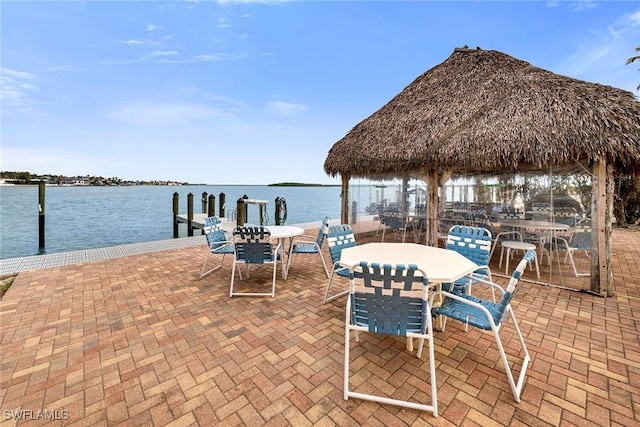 view of patio / terrace featuring a boat dock, a water view, and a gazebo