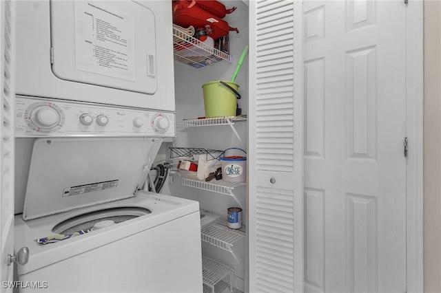 laundry area featuring stacked washer and clothes dryer