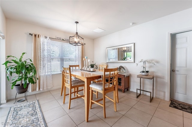 dining area with a notable chandelier and light tile patterned floors