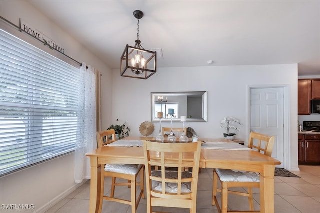 dining area featuring an inviting chandelier, plenty of natural light, and light tile patterned floors