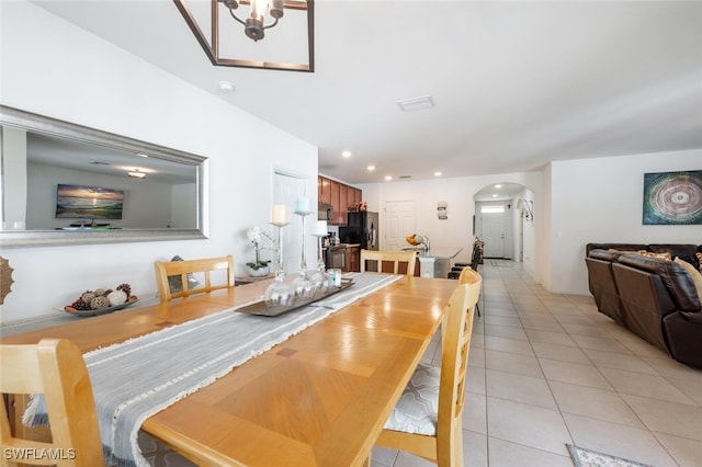 tiled dining space with a notable chandelier