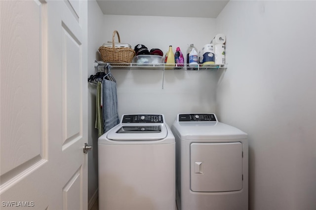 clothes washing area with washing machine and clothes dryer