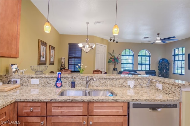 kitchen with ceiling fan with notable chandelier, stainless steel dishwasher, light stone counters, and sink