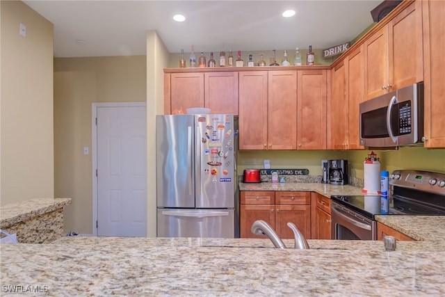 kitchen featuring light stone countertops and appliances with stainless steel finishes