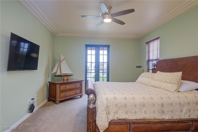 carpeted bedroom with ceiling fan, ornamental molding, french doors, and multiple windows