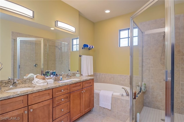 bathroom featuring vanity, tile patterned floors, and shower with separate bathtub