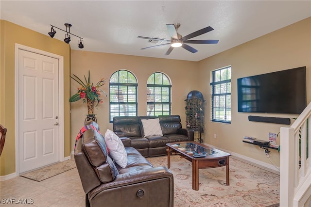 living room featuring ceiling fan, a wealth of natural light, and light tile patterned flooring