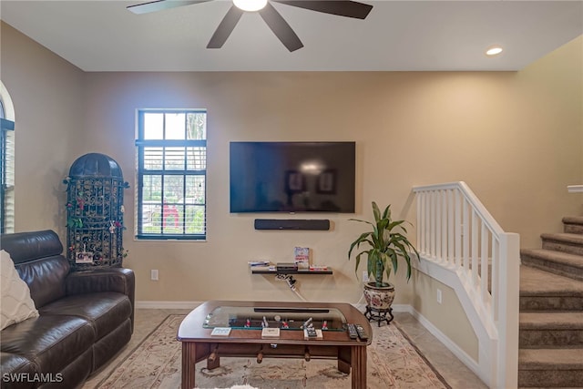 living room with ceiling fan and light tile patterned flooring