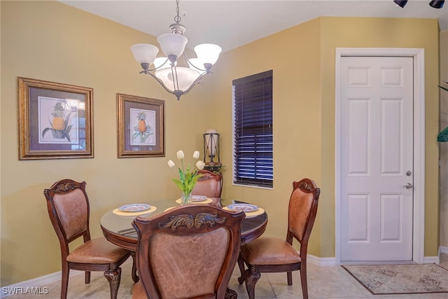 dining room with light tile patterned floors and a chandelier