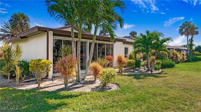 rear view of house with a yard