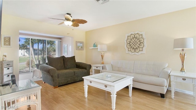 living room featuring ceiling fan and light hardwood / wood-style flooring