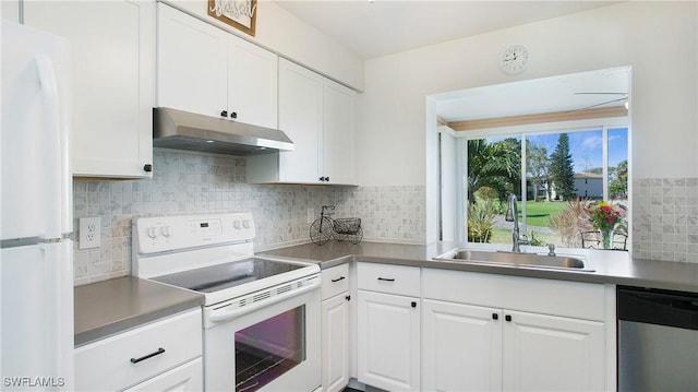 kitchen featuring sink, white cabinets, tasteful backsplash, and white appliances