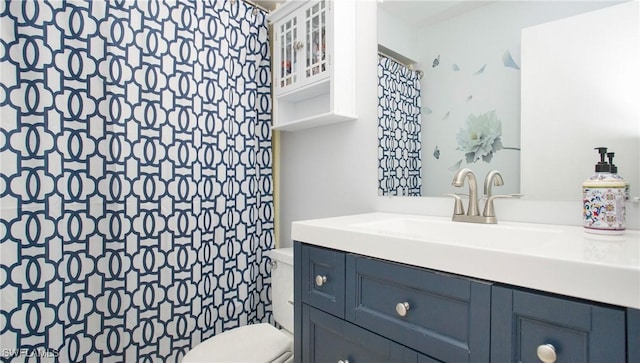 bathroom with toilet and vanity