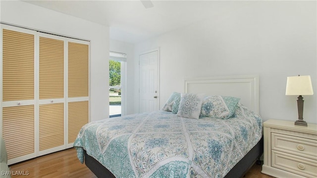 bedroom with ceiling fan, a closet, and light hardwood / wood-style floors