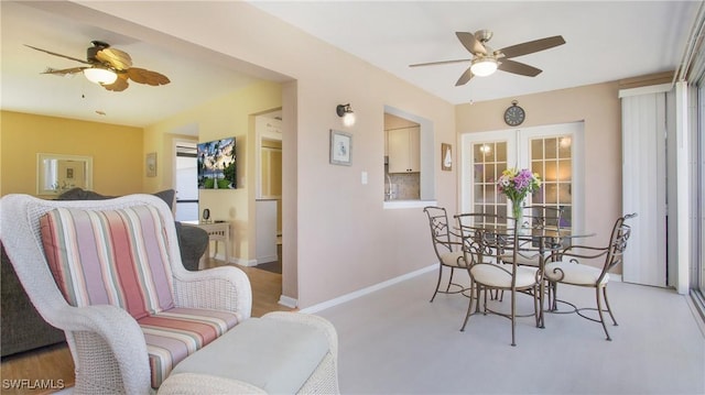 dining room with ceiling fan and french doors