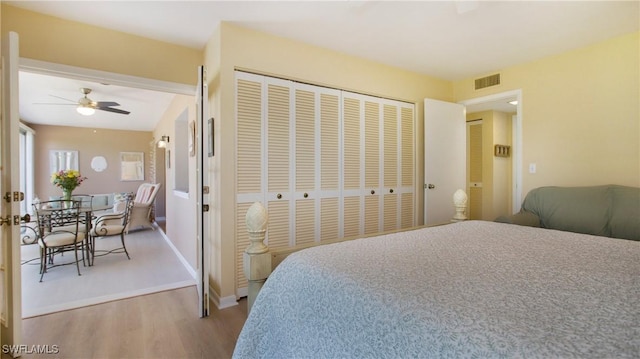 bedroom with ceiling fan, a closet, and hardwood / wood-style floors