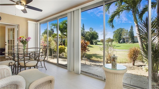 entryway with floor to ceiling windows and ceiling fan