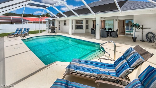 view of pool featuring a lanai, area for grilling, ceiling fan, and a patio area