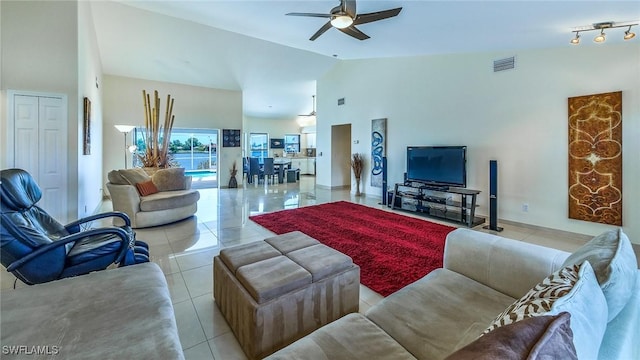 tiled living room featuring vaulted ceiling and ceiling fan