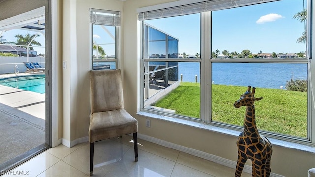 sunroom / solarium with a water view