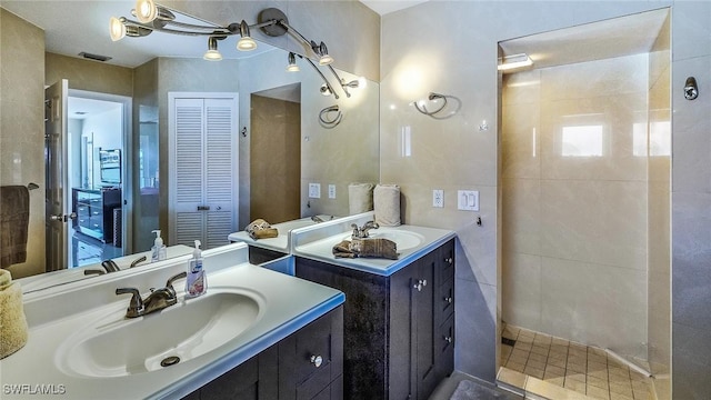 bathroom with vanity, tile walls, and walk in shower