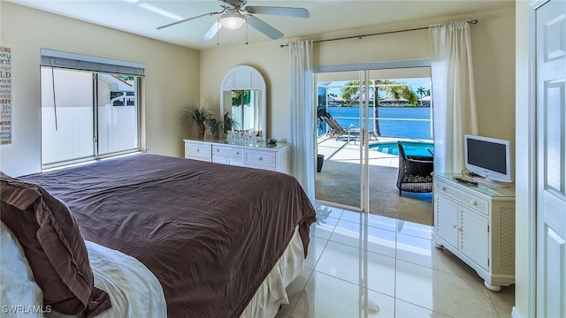 bedroom with ceiling fan, light tile patterned floors, and access to exterior