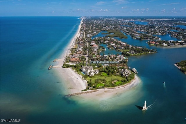 bird's eye view featuring a water view and a beach view