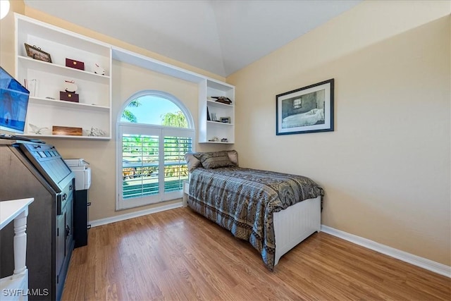 bedroom featuring lofted ceiling and hardwood / wood-style floors