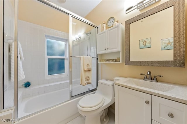 full bathroom with toilet, bath / shower combo with glass door, and vanity