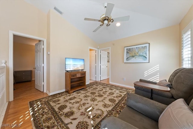 living room with ceiling fan, light wood-type flooring, and high vaulted ceiling