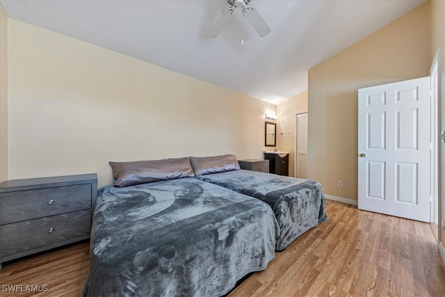 bedroom featuring a closet, ceiling fan, vaulted ceiling, and wood-type flooring