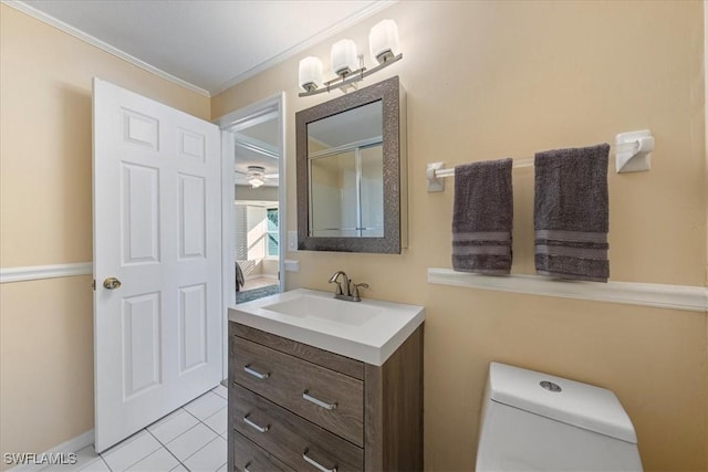 bathroom featuring vanity, tile patterned flooring, toilet, and ornamental molding