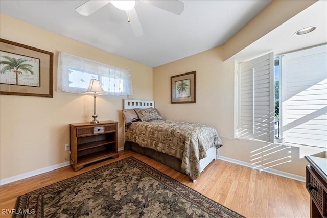 bedroom with ceiling fan and light hardwood / wood-style floors