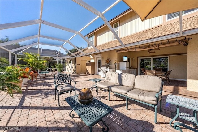 view of patio / terrace featuring a lanai, area for grilling, and an outdoor living space