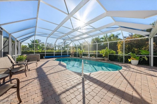 view of swimming pool with a lanai, a hot tub, and a patio