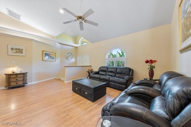 living room with ceiling fan, light wood-type flooring, and vaulted ceiling